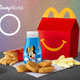 McDonald’s toys next to red Happy Meal box and nuggets